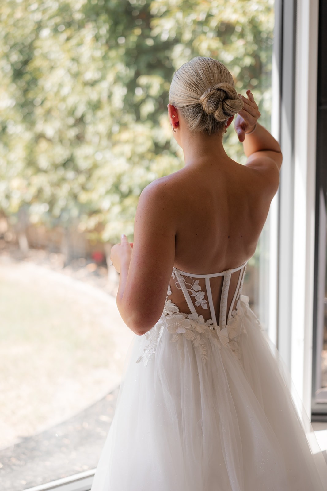 Carla — bride at a sunlit window